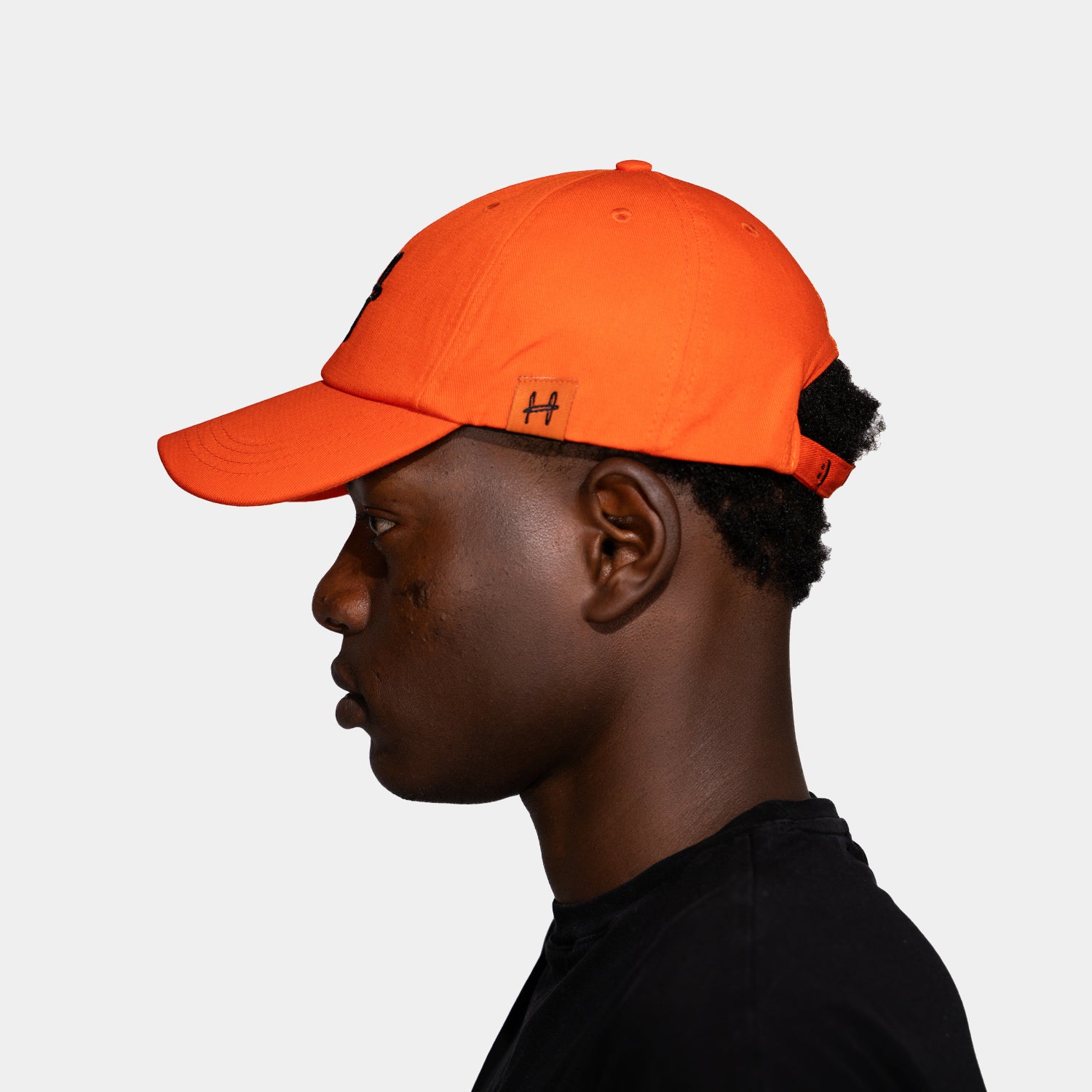 a cap with an h on it